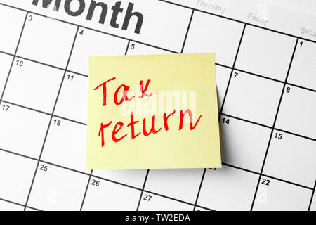 Note with text and calendar. Tax return concept Stock Photo