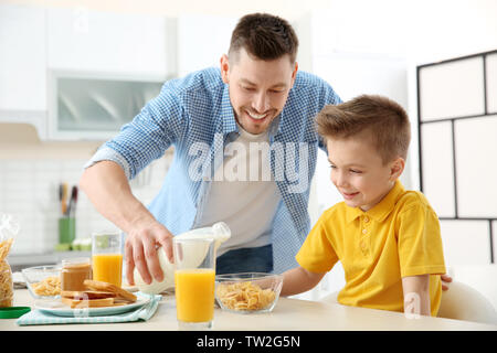 Dad and son having lunch at home Stock Photo