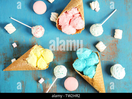 Composition with different ice cream in waffle cones on wooden background Stock Photo