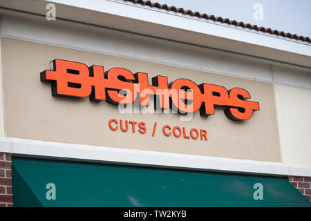 Storefront sign with some sky and clouds. June 2019. Southern Indiana. Bishops Cuts / Color Stock Photo