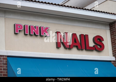 Storefront sign with some sky and clouds. June 2019. Southern Indiana. Pink Nails. Stock Photo