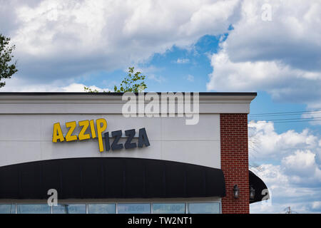 Storefront sign with some sky and clouds. June 2019. Southern Indiana Azzip Pizza Stock Photo