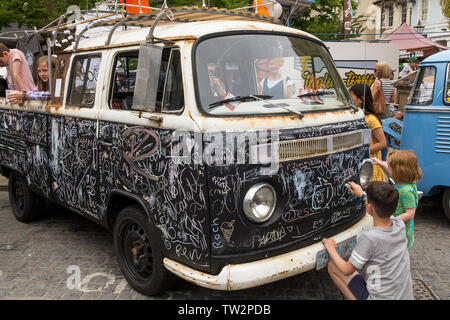 Volkswagen pick up truck in black board paint for children to draw or write on  with coloured colored chalk chalks at a VW event in Horsham town UK Stock Photo