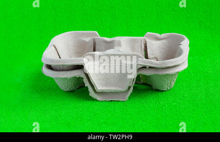 Two paper cups with takeaway drinks. Isolated on green background.Pressed cardboard paper double cup holder Stock Photo