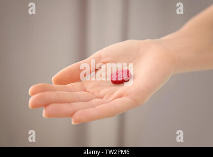 Female hand with rat poison on blurred background Stock Photo