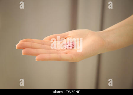 Female hand with rat poison on blurred background Stock Photo