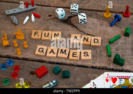 'Fun and Games' made from Scrabble game letters, Risk, Battleship pieces, Monopoly, Settler of Catan and other game pieces Stock Photo