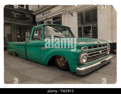 Lowered Ford pick up truck green colour color pop black and white conversion  extreme lowered body on public town centre vehicle event show Horsham UK Stock Photo