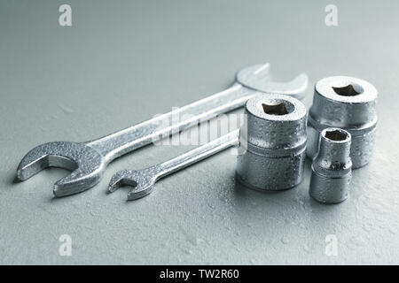 Hand sockets and spanners on light background Stock Photo