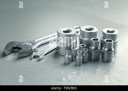 Hand sockets and spanners on light background Stock Photo