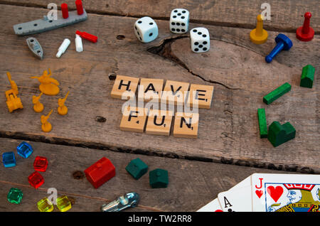 'Have Fun' made from Scrabble game letters, Risk, Battleship pieces, Monopoly, Settler of Catan and other game pieces Stock Photo