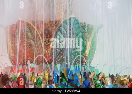 Fragment of colorful mosaic fountain in shape of  fabulous stone flower made of gems Stock Photo