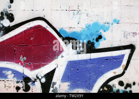 White brick wall shabby wall with fragment of colorful graffiti for grungy urban background Stock Photo