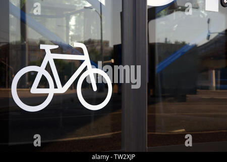 Bicycle icon on automatic glass bus door. Public transport equipped to bicyclist convenience. Intercity tourist bus adapted for transporting bicycles Stock Photo