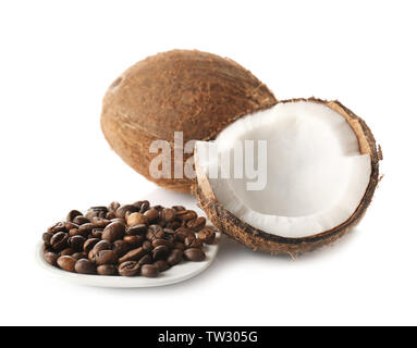 Saucer with coffee beans and coconuts on white background Stock Photo