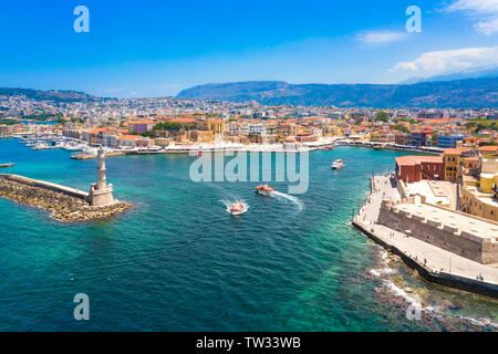 Panorama of the beautiful old harbor of Chania with the amazing lighthouse, mosque, venetian shipyards, Crete, Greece. Stock Photo