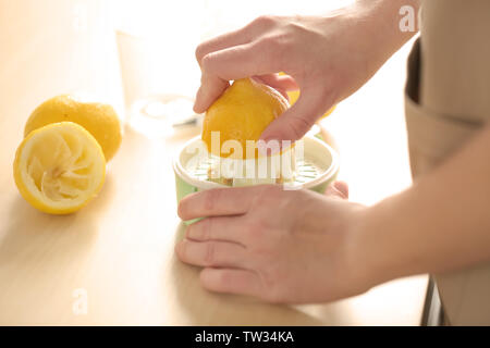 Woman preparing lemonade in kitchen, closeup Stock Photo