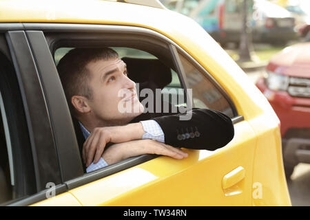 Handsome man on backseat in taxi Stock Photo