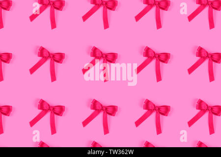 Pink silk gift bow isolated on pink. Stock Photo