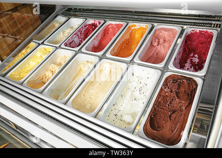 Containers with different sorts of ice cream in gelateria Stock Photo