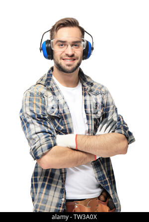Young smiling carpenter standing with crossed hands on white background Stock Photo