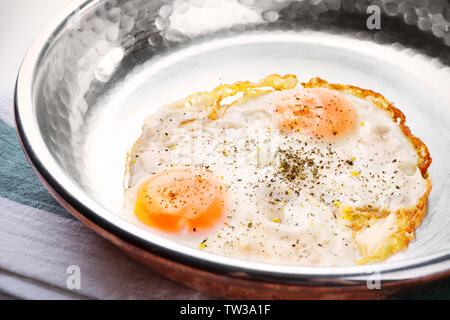Pan with over hard fried eggs, closeup Stock Photo
