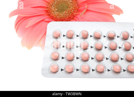 Oral contraception concept. Birth control pills and beautiful flower on white background, closeup Stock Photo