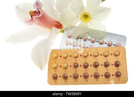 Oral contraception concept. Birth control pills and beautiful flowers on white background Stock Photo