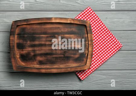 Empty rectangular wooden plate and napkin on table Stock Photo
