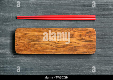 Rectangular wooden board and chopsticks on table Stock Photo