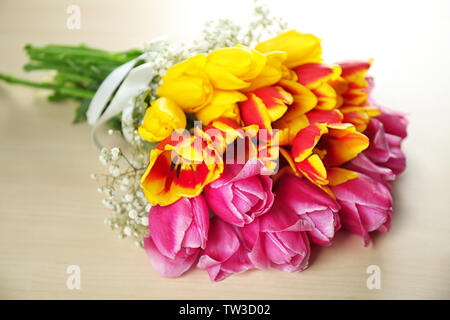 Beautiful bouquet of spring flowers on light table Stock Photo