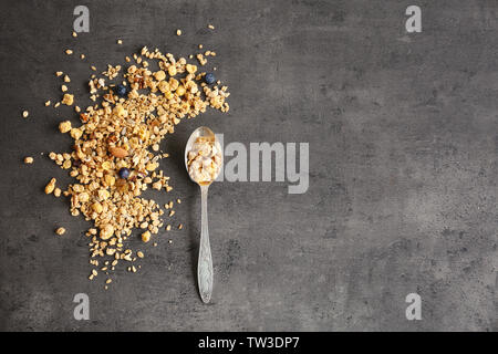 Silver spoon with muesli on gray background Stock Photo