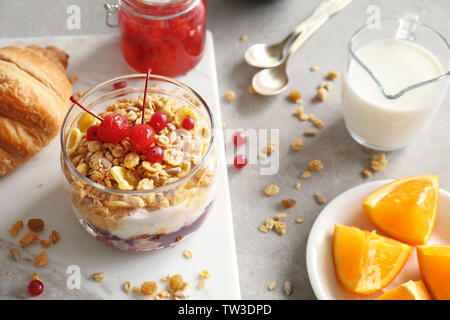 Healthy breakfast with muesli, berries and yogurt on table Stock Photo