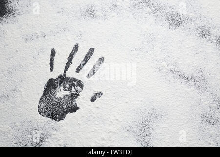 Hand print on scattered flour Stock Photo