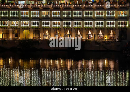 Night view on architecture and lake water in Udaipur, Rajasthan, India. Udaipur is one of the most visited tourist destinations in India. Stock Photo