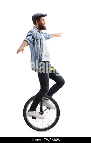Full length shot of a young man on a unicycle balancing with hands isolated on white background Stock Photo