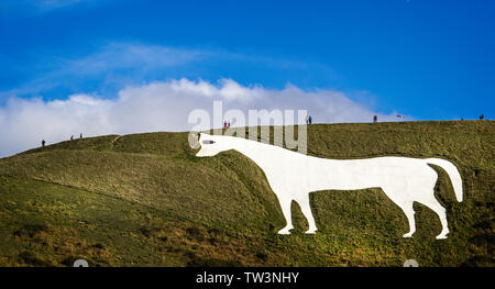 View of Westbury White Horse in Wiltshire, UK with  people walking above it Stock Photo