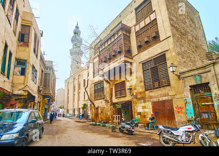 CAIRO, EGYPT - DECEMBER 22, 2017: Bab Al-Wazir street with preserved historic mansion and Umm Al-Sultan Shaban Mosque and Madrasa on background, on De Stock Photo