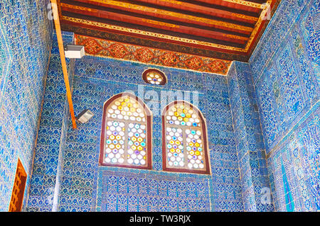 CAIRO, EGYPT - DECEMBER 22, 2017: The bright blue tile wall of Ibrahim Agha Mustahfizan Mausoleum of Aqsunqur (Blue) Mosque is decorated with vintage Stock Photo