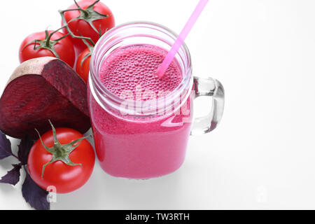 Mason jar with fresh vegetable juice an d ingredients on white background Stock Photo