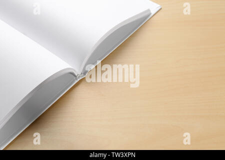 Blank pages of opened book on wooden background Stock Photo
