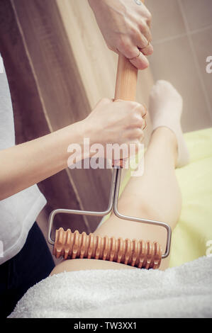 Anti-cellulite treatment. Young woman having a maderotherapy massage treatment at spa salon Stock Photo