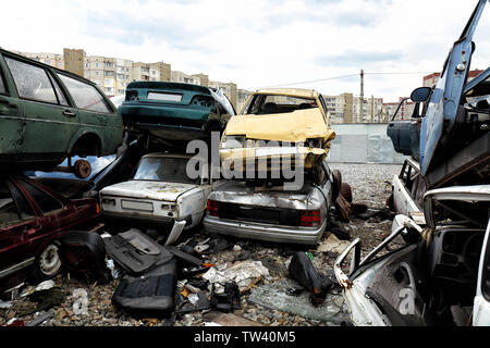 Piled crushed cars on salvage yard Stock Photo