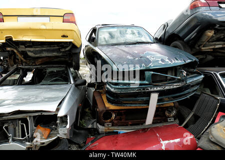 Piled crushed cars on salvage yard Stock Photo