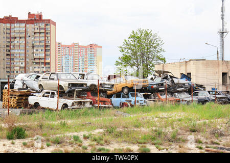 Piled crushed cars on salvage yard Stock Photo