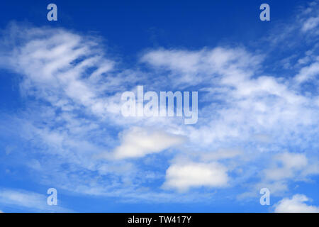 A thin spread of cloud over a blue sky creating a beautiful background scene Stock Photo