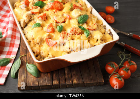 Delicious roasted turkey tetrazzini in baking dish on kitchen table Stock Photo