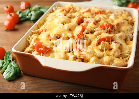 Delicious roasted turkey tetrazzini in baking dish on kitchen table Stock Photo