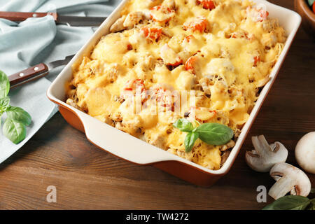 Delicious roasted turkey tetrazzini in baking dish on kitchen table Stock Photo