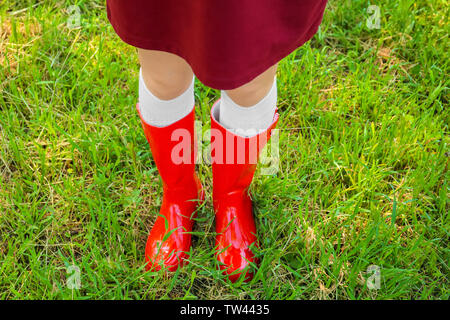 Young woman in red wellington boots outdoors Stock Photo